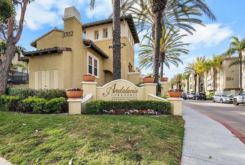 Andalucia Townhomes entrance sign with palm trees